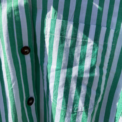 Close-up of a green and white striped shirt with buttons.