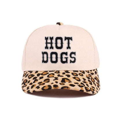 Cap with 'HOT DOGS' text and leopard print brim on a white background