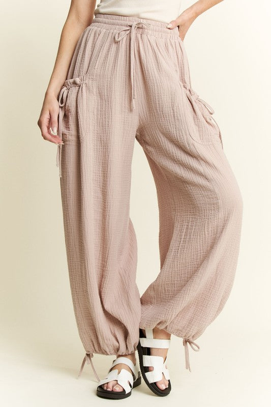 Light wide-leg pants worn by a person on a beige background