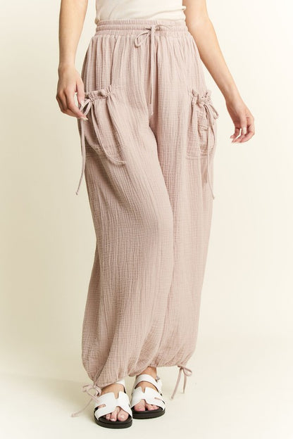 Light pink wide-leg pants worn by a person on a plain background