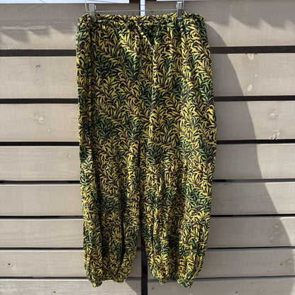 Folded green and yellow patterned fabric on a wooden surface