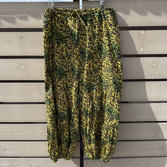 Folded green and yellow patterned fabric on a wooden surface