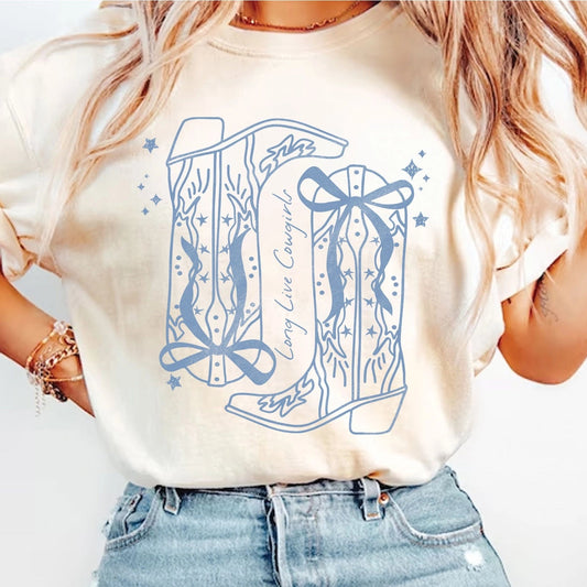 Person wearing a white t-shirt with blue graphic design and high-waisted jeans on a plain background