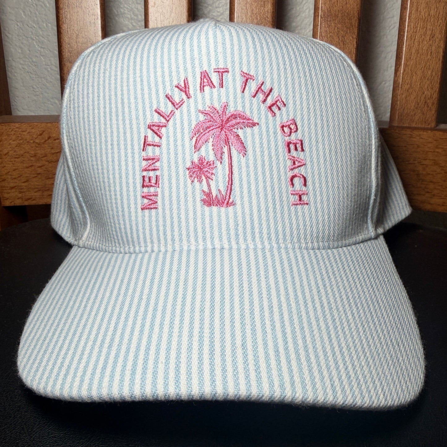 Cap with pink text and palm tree design