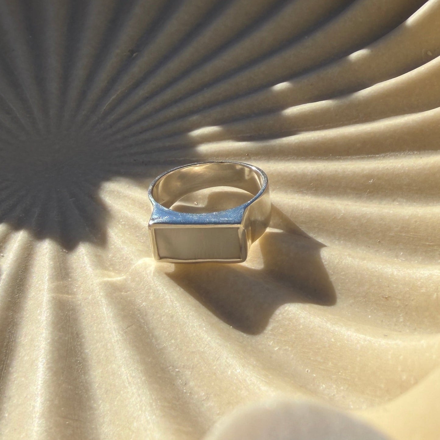 Close-up of a beige textured surface with a silver ring on it