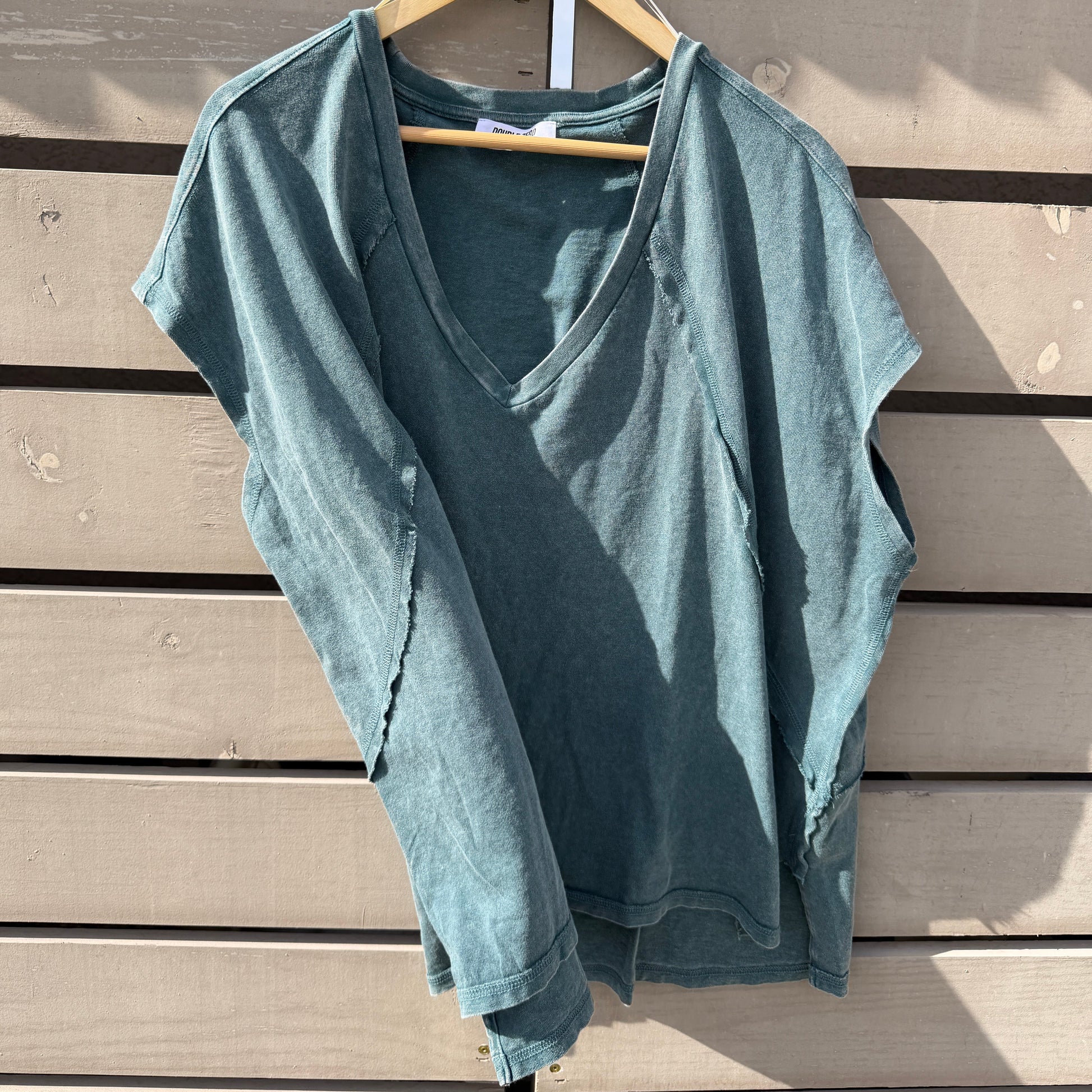 Dark teal shirt on a wooden surface