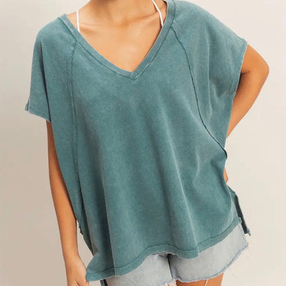 Teal oversized t-shirt worn by a person on a plain background