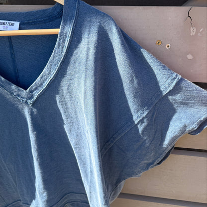 Blue shirt on a hanger against a neutral background