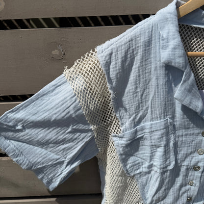 Light blue textured shirt with a patterned patch