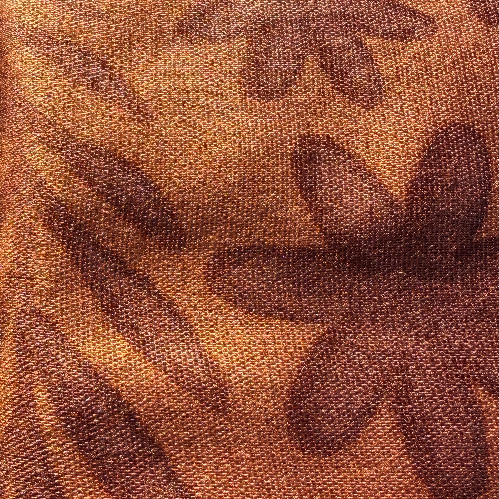 Brown fabric with floral pattern on grass