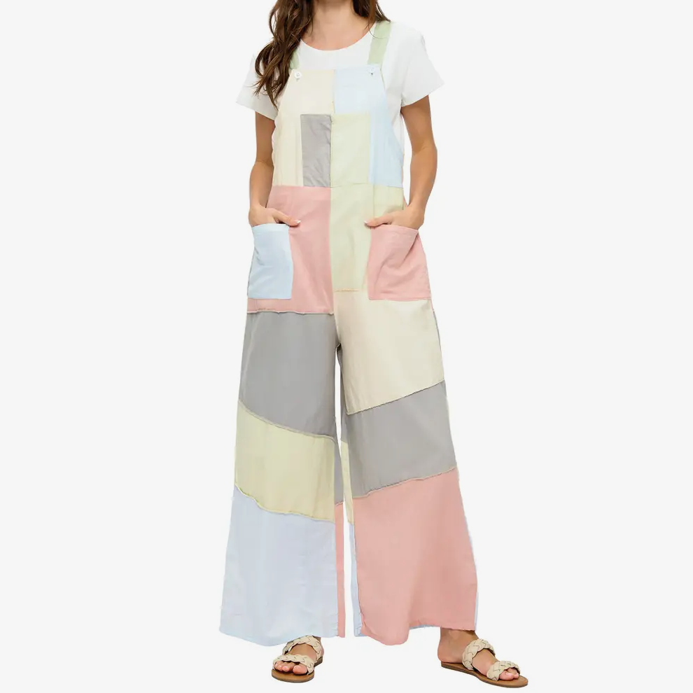 Woman wearing a colorful geometric-patterned jumpsuit on a white background