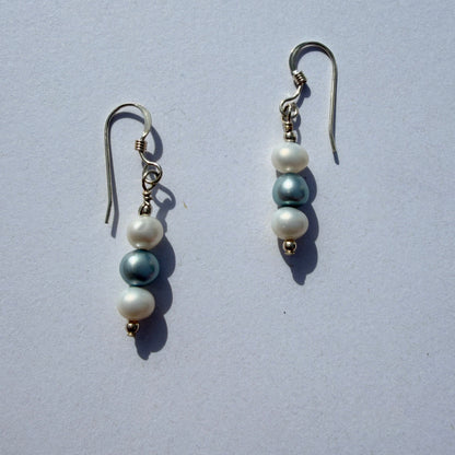 Pair of pearl earrings on a light gray background