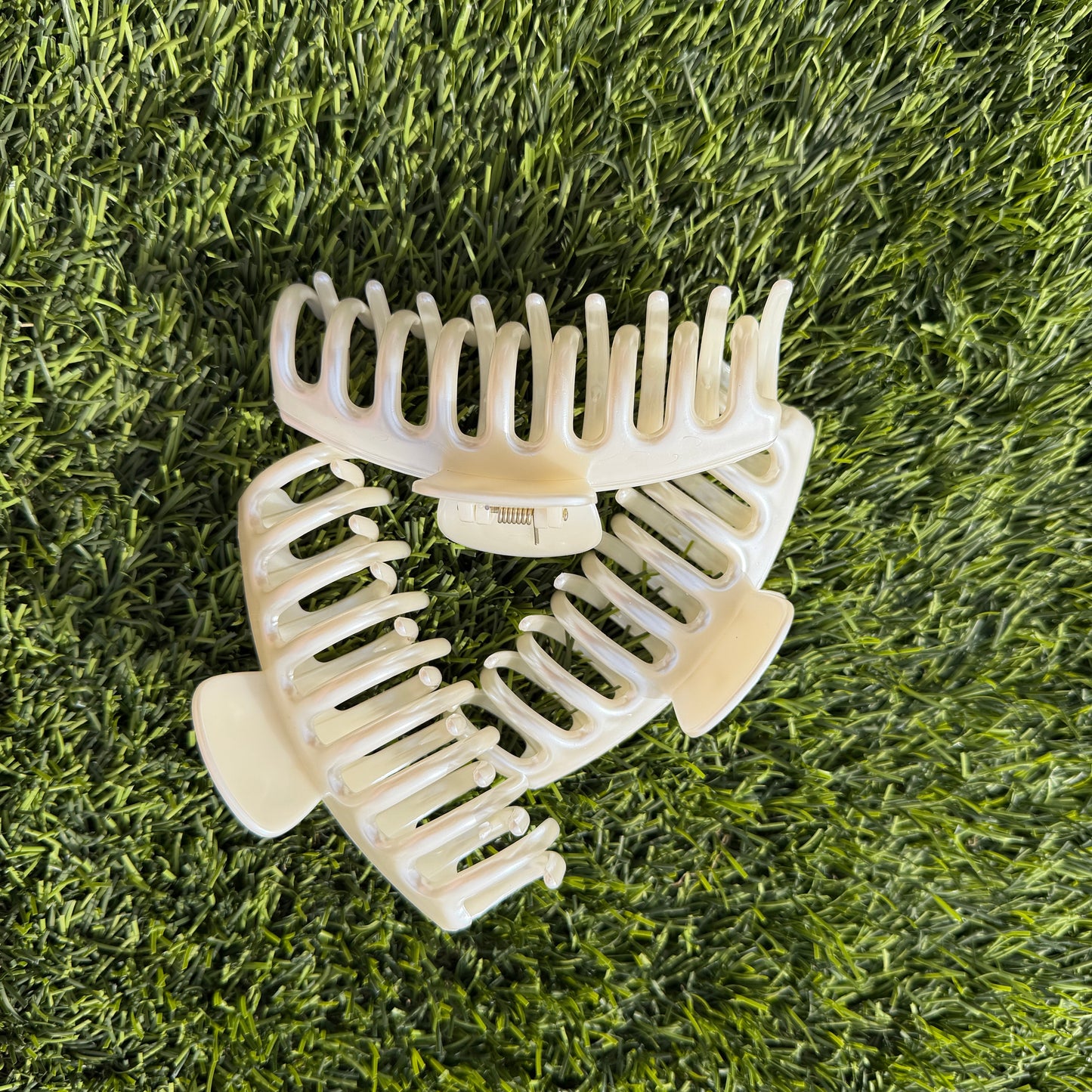 Pearl hair clips on a grassy surface