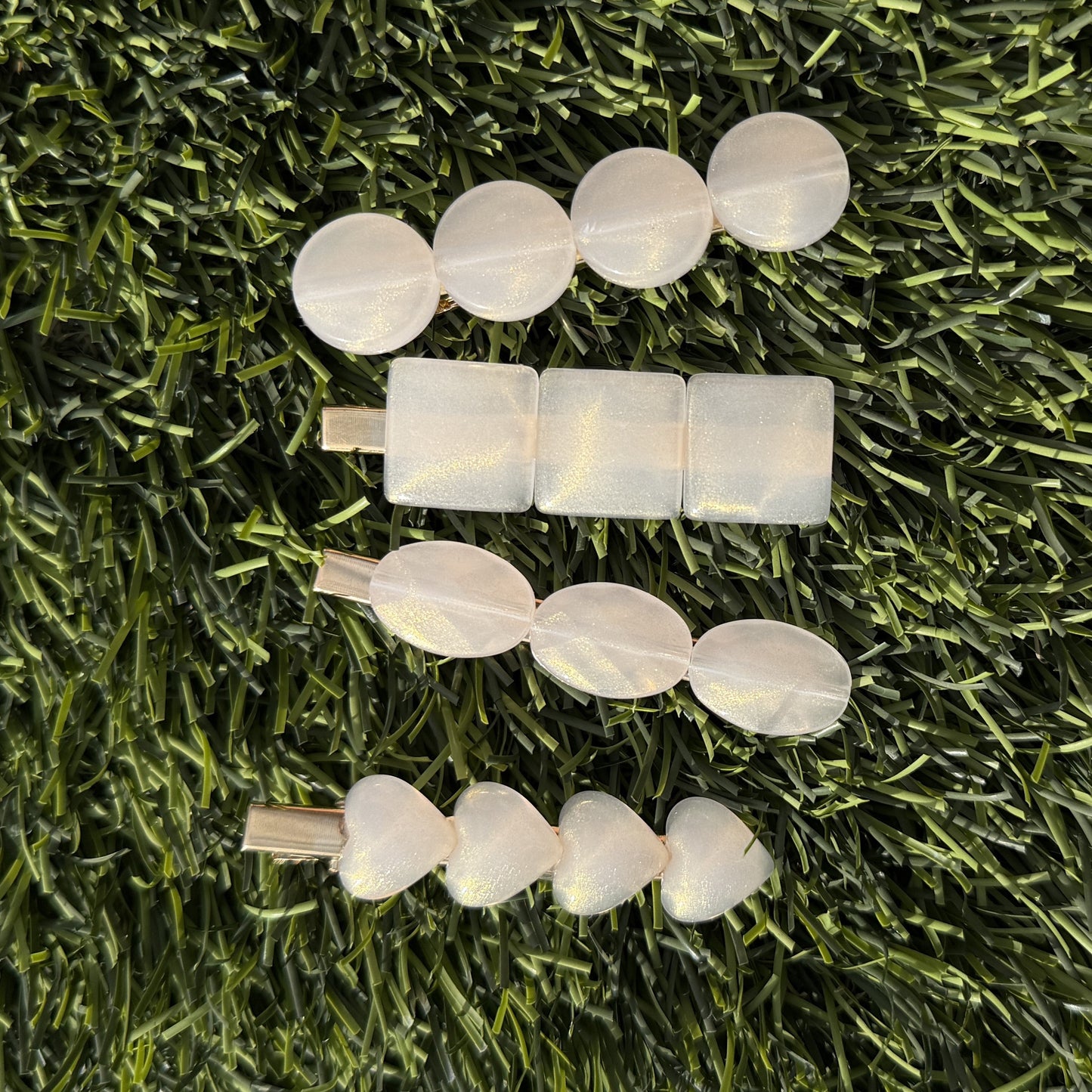 Set of hair clips on a grassy background