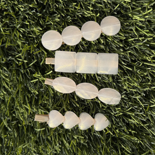 Set of hair clips on a grassy background