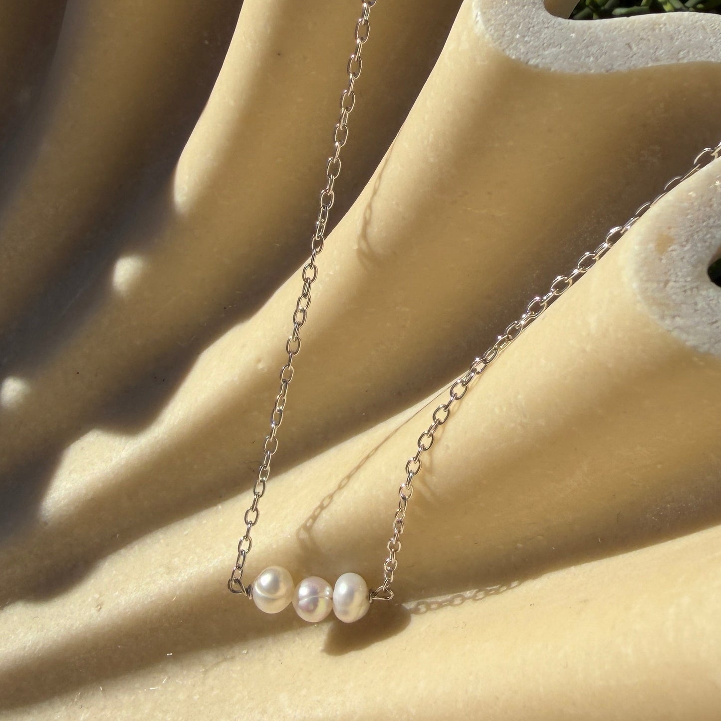 Necklace with pearls on a beige  background