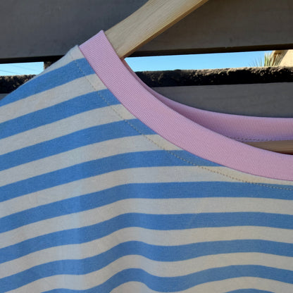 Close-up of a blue and white striped fabric with a pink trim.