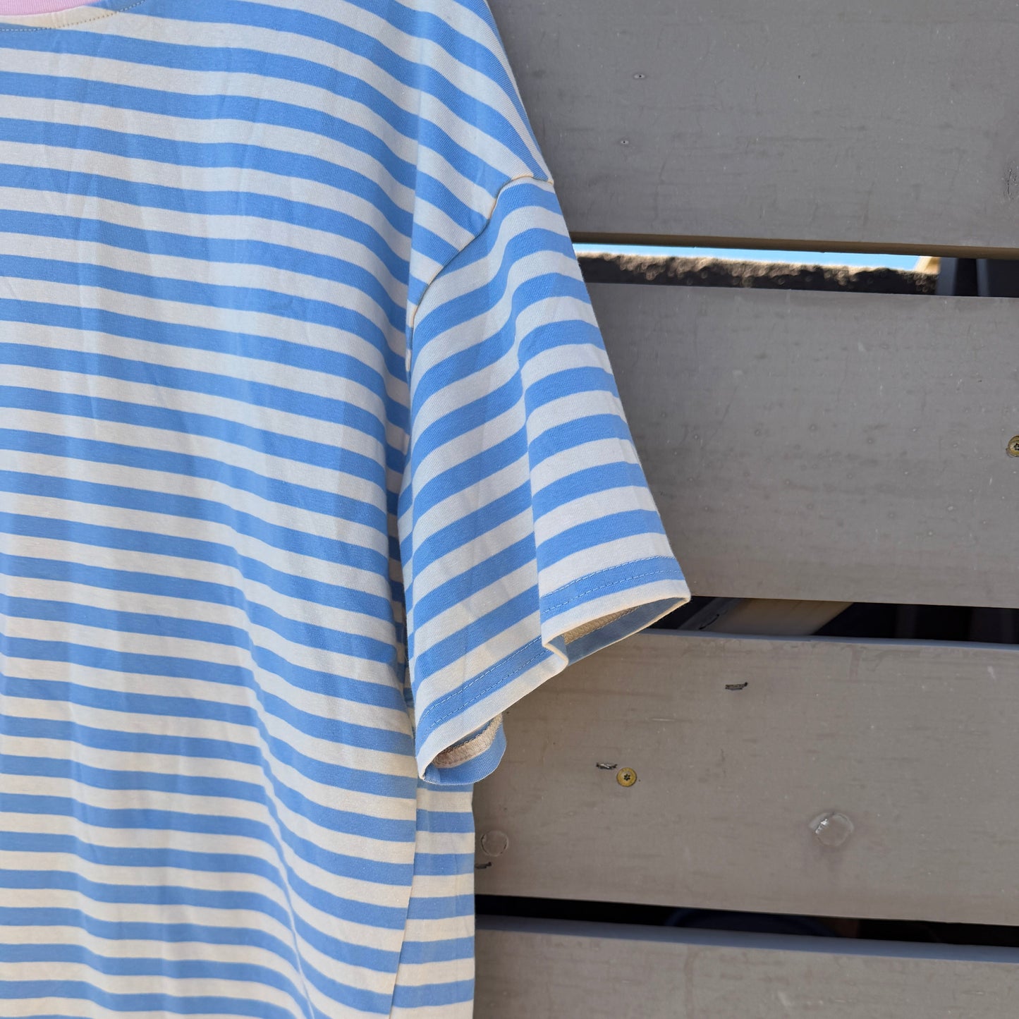 Blue and white striped shirt draped over a metal surface