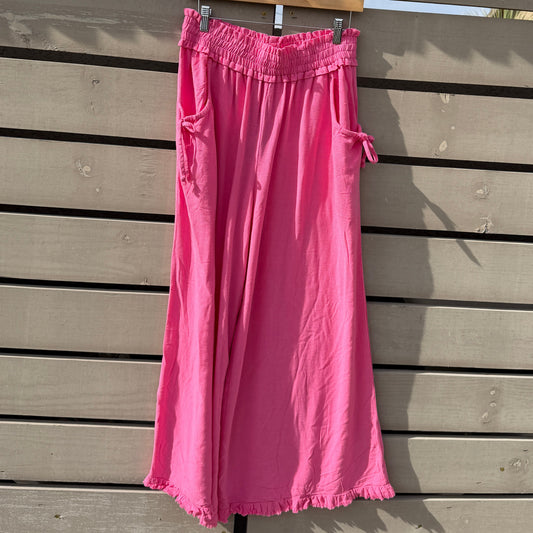 Pink pants on a wooden deck with a lattice structure