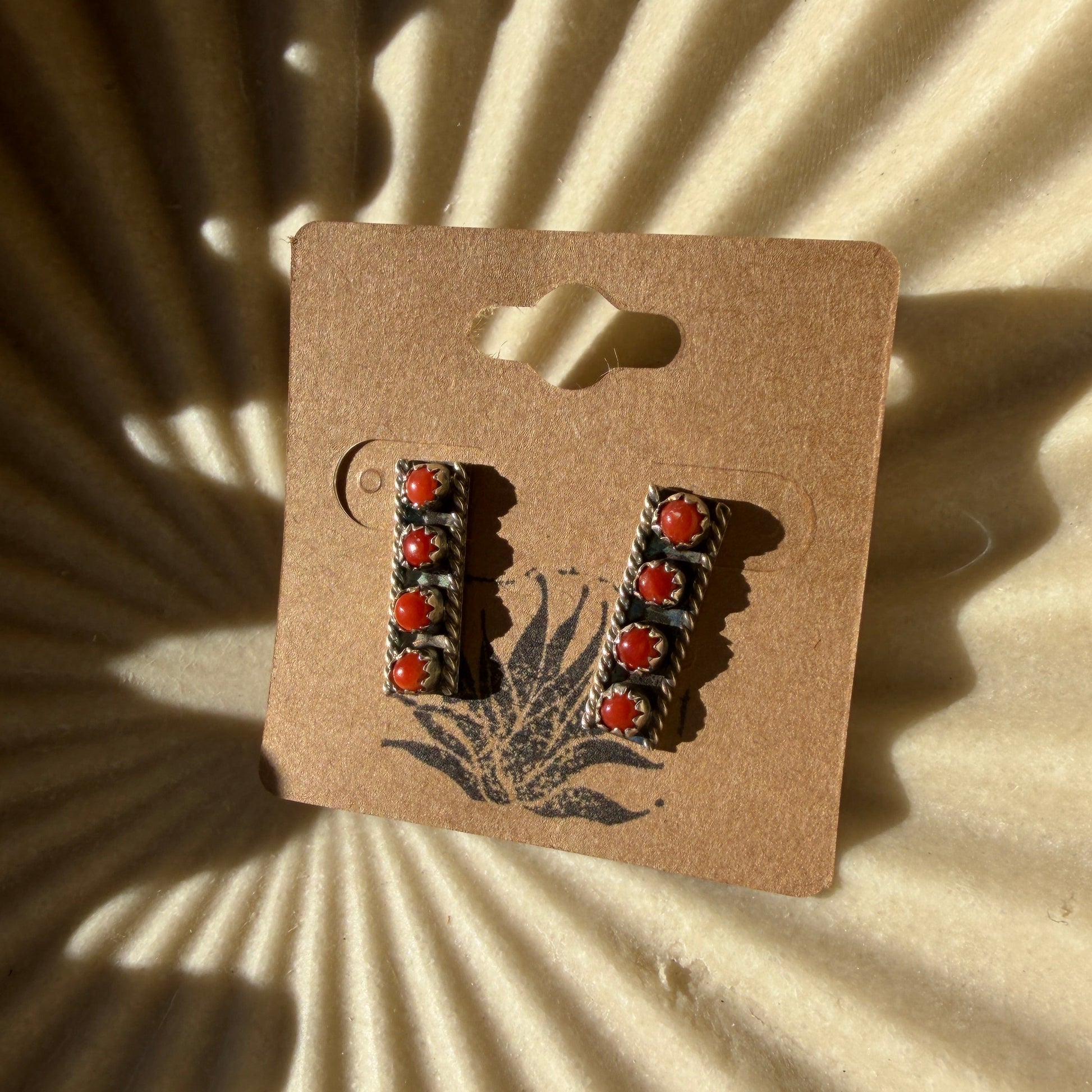 earrings on beige background