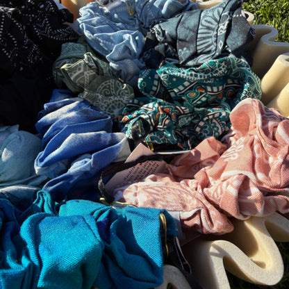 Collection of colorful scrunchies on a grassy background