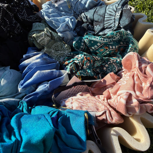 Collection of colorful scrunchies on a grassy background