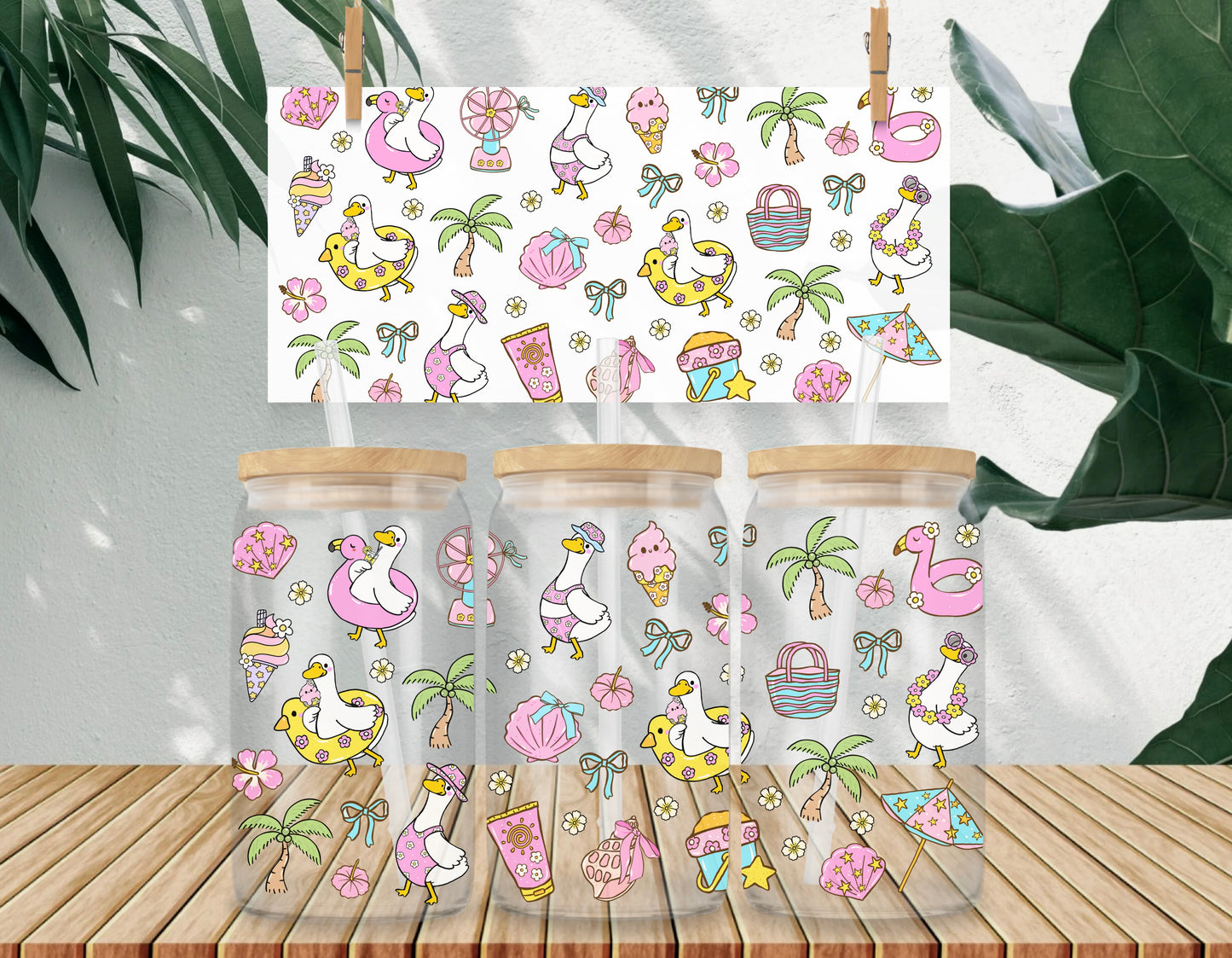 Three clear jars with wooden lids on a wooden surface, featuring a colorful pattern of flamingos, ice cream, and palm trees.