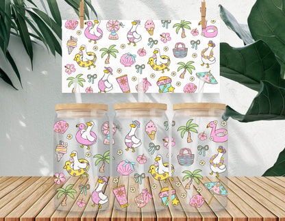 Three clear jars with wooden lids on a wooden surface, featuring a colorful pattern of flamingos, ice cream, and palm trees.