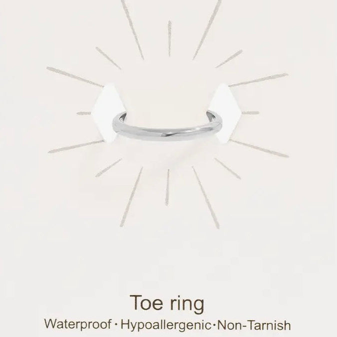 Silver toe ring on a white card