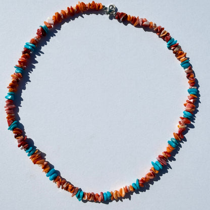 Colorful beaded necklace on a light gray background
