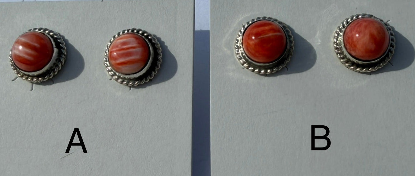 Pair of sterling silver earrings with spiny oyster on display cards.