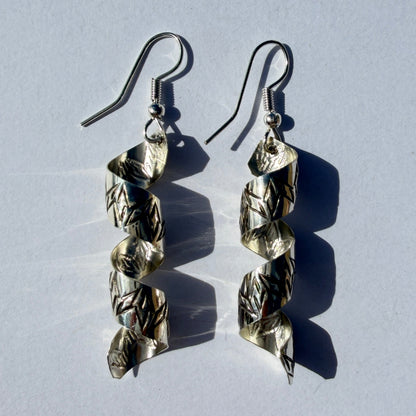 Pair of silver earrings on a light gray background