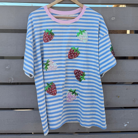 Blue and white striped t-shirt with strawberry designs on a wooden background