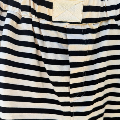 Close-up of black and white striped shorts with a pocket visible.