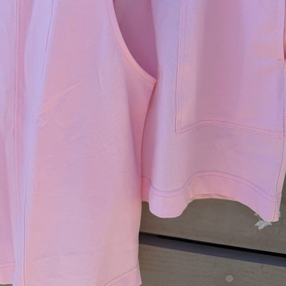 Pink shirt on a hanger with a neutral background