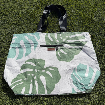 Tote bag with green leaf pattern on grass